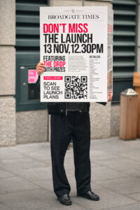 Surrealist capture of a person holding a large 'Broadgate Times' sign that completely replaces their torso and head.